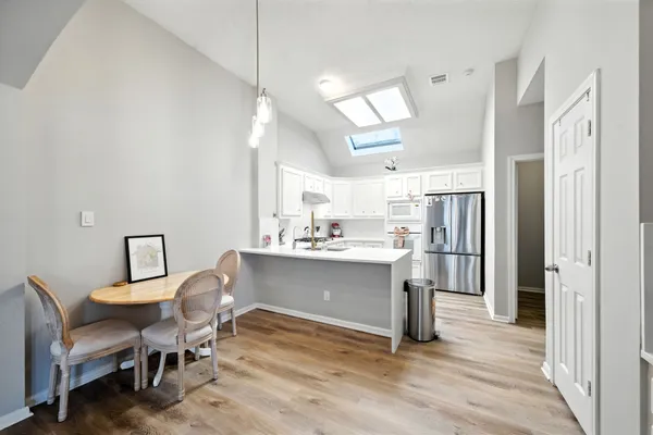 a view of a dining room with furniture and wooden floor