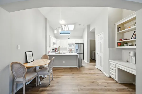 a view of a dining room with furniture and wooden floor