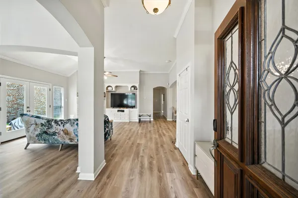 a view of a living room with furniture and wooden floor