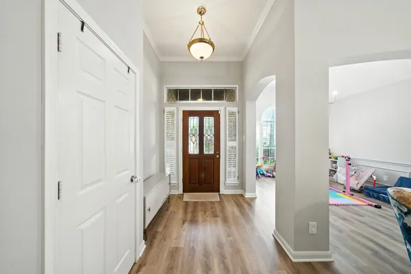 a view of a hallway view with wooden floor and windows
