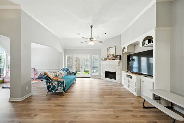 a living room with furniture flat screen tv and a fireplace