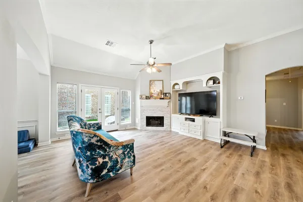 a living room with furniture a flat screen tv and a fireplace