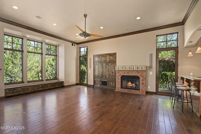 a kitchen with stainless steel appliances granite countertop a table chairs sink and cabinets