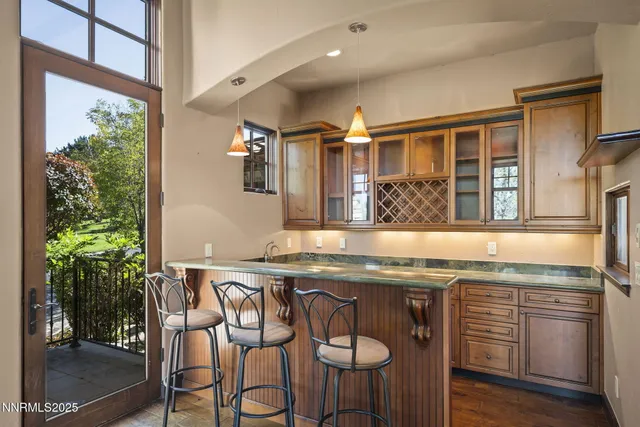 a kitchen with a sink a counter top space and chandelier