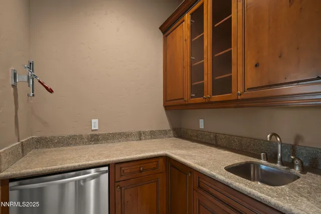 a view of a big room with wooden floor and windows