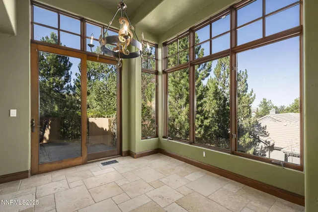 a view of room with wooden floor and windows
