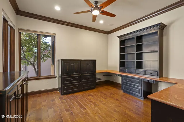 an empty room with chandelier and stainless steel appliances