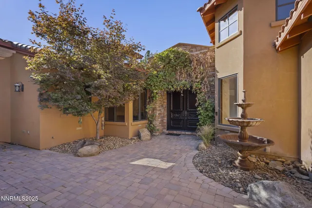 a view of a livingroom with a fireplace wooden floor and windows