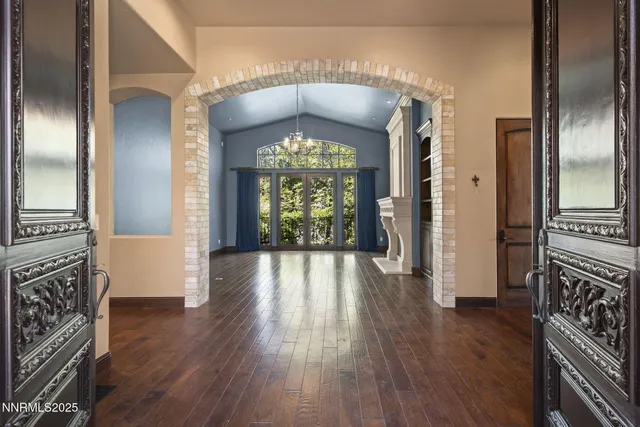 wooden floor fireplace and windows in an empty room