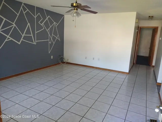 an empty room with a wooden door and a shower