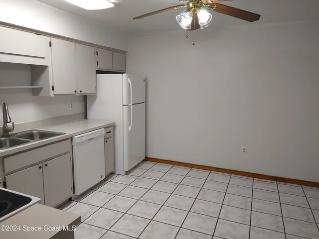 a kitchen with a sink cabinets and appliances