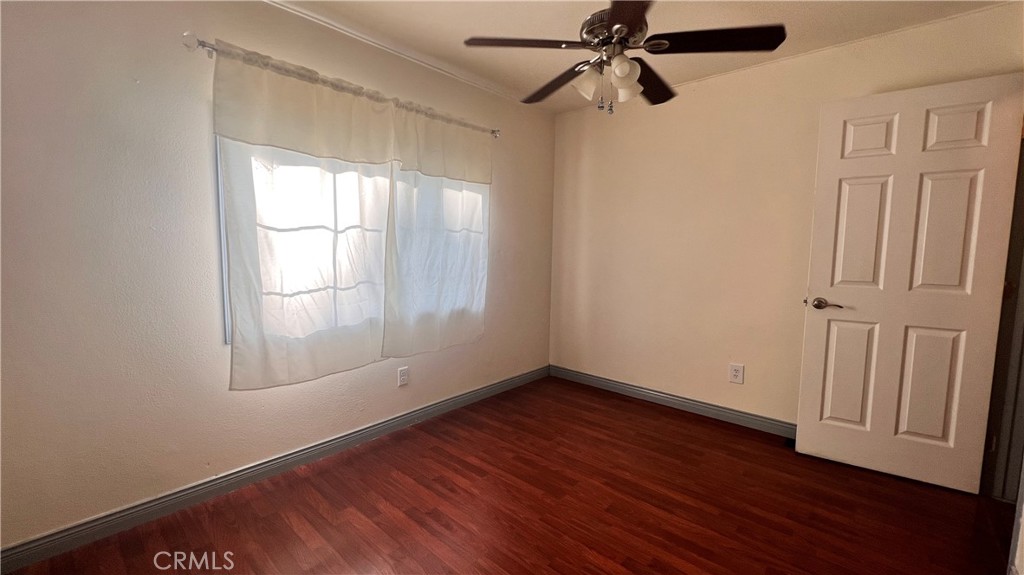 2135 Nord Avenue, Unit 33 Chico, CA 95926 - Photo 12 of 35 an empty room with wooden floor fan and windows