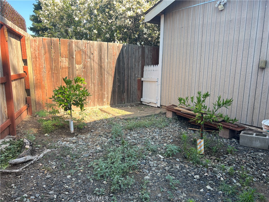 2135 Nord Avenue, Unit 33 Chico, CA 95926 - Photo 23 of 35 a backyard with potted plants and a wooden fence