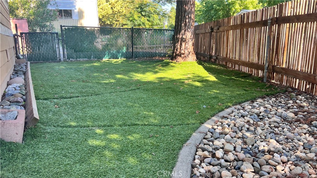 2135 Nord Avenue, Unit 33 Chico, CA 95926 - Photo 28 of 35 a view of a backyard with a small cabin and a chair
