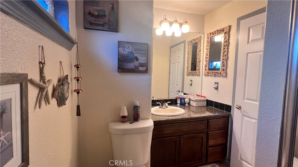 2135 Nord Avenue, Unit 33 Chico, CA 95926 - Photo 10 of 35 a bathroom with a sink a toilet a mirror and shower