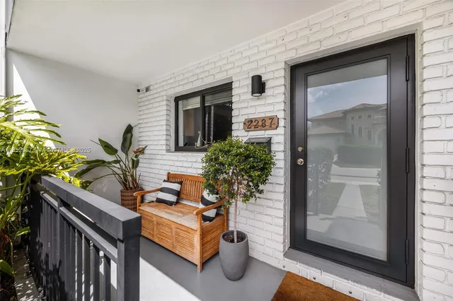 a potted plant is sitting in front of a glass door