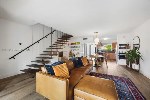a living room with furniture and wooden floor