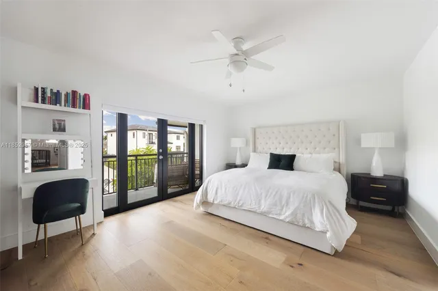 a bedroom with a large bed and glass window