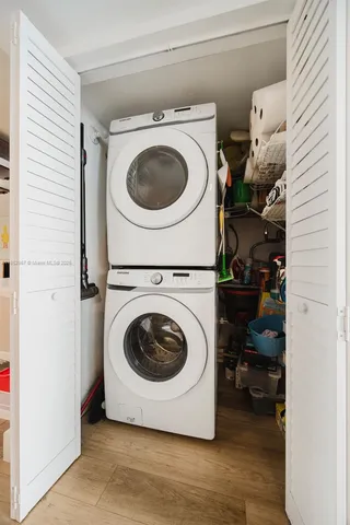 a view of a patio with table and chairs potted plants and large tree