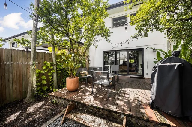 a view of a house with backyard garden and sitting area