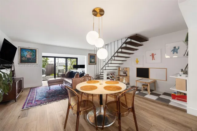 a dining room with furniture and wooden floor