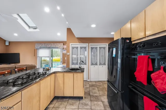 a kitchen with stainless steel appliances granite countertop a stove and a refrigerator