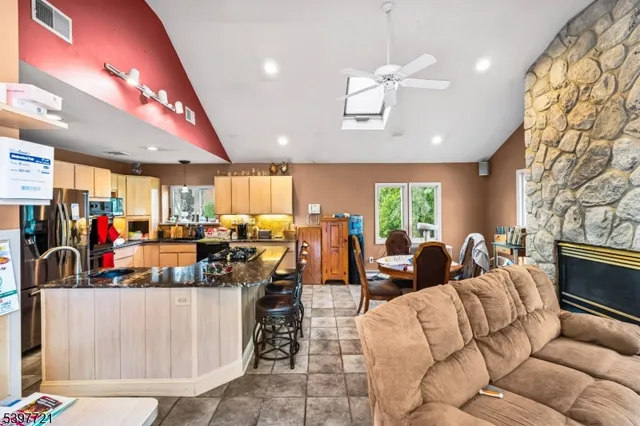 a living room with lots of furniture and kitchen view
