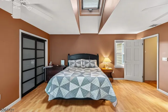 a bed sitting in a bedroom next to a window