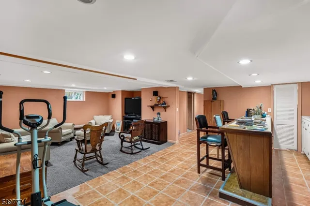 a dining area with a table chairs and a kitchen view