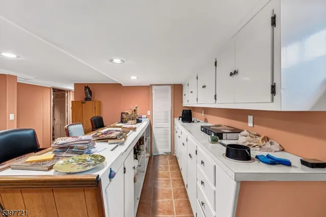 a living room with furniture a rug and white walls