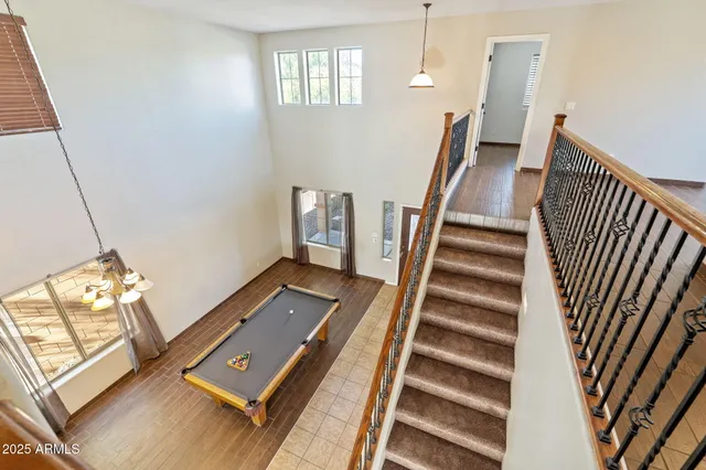 a view of a workspace with furniture and stairs