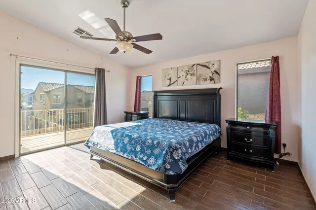 a bedroom with a large bed and a large window