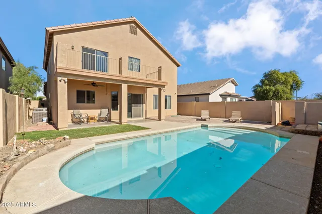 a view of a house with swimming pool and a yard