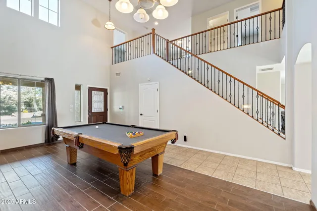 a room with gym equipment and wooden floor
