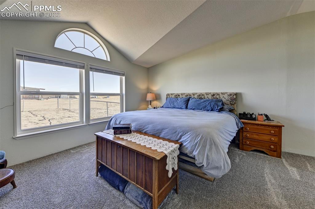 13190 South Lauppe Road Yoder, CO 80864 - Photo 20 of 38 a bedroom with a bed a window and dresser