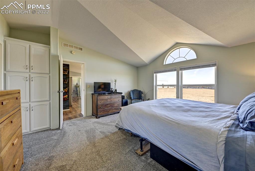 13190 South Lauppe Road Yoder, CO 80864 - Photo 22 of 38 a bed room with a bed and a television