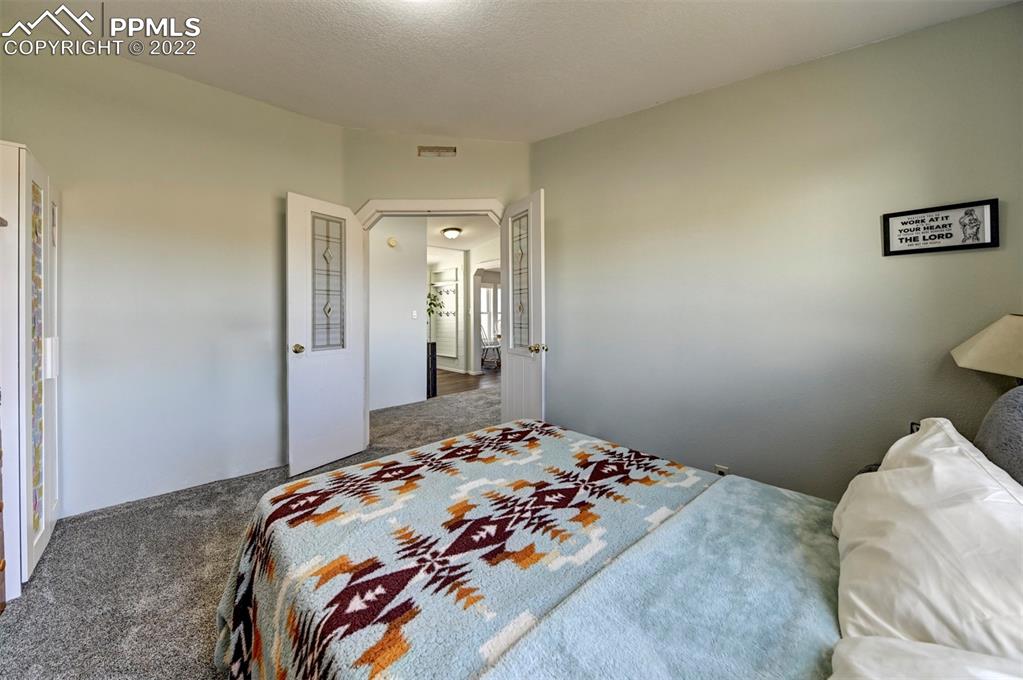 13190 South Lauppe Road Yoder, CO 80864 - Photo 26 of 38 a bedroom with a bed and a painting on the wall