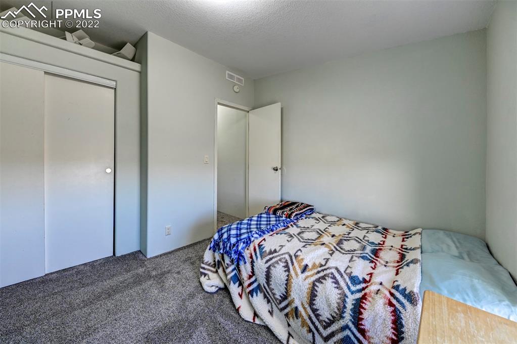 13190 South Lauppe Road Yoder, CO 80864 - Photo 28 of 38 a bedroom with a bed and a window