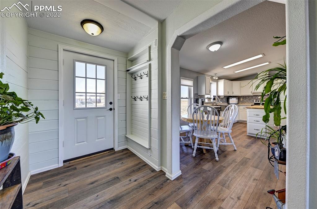 13190 South Lauppe Road Yoder, CO 80864 - Photo 3 of 38 a view of entryway with livingroom and wooden floor