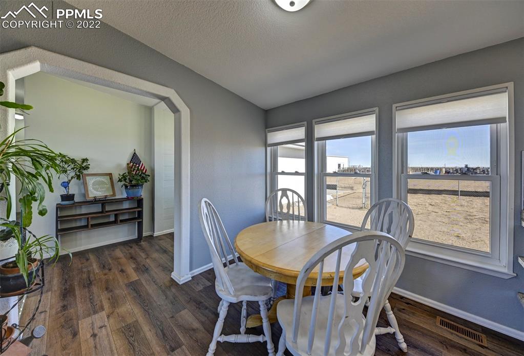 13190 South Lauppe Road Yoder, CO 80864 - Photo 6 of 38 a view of a dining room with furniture window and wooden floor