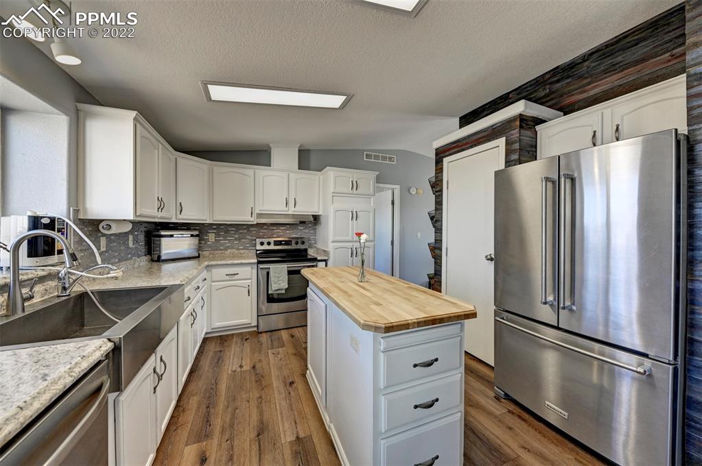 13190 South Lauppe Road Yoder, CO 80864 - Photo 8 of 38 a kitchen with a refrigerator sink and stainless steel appliances