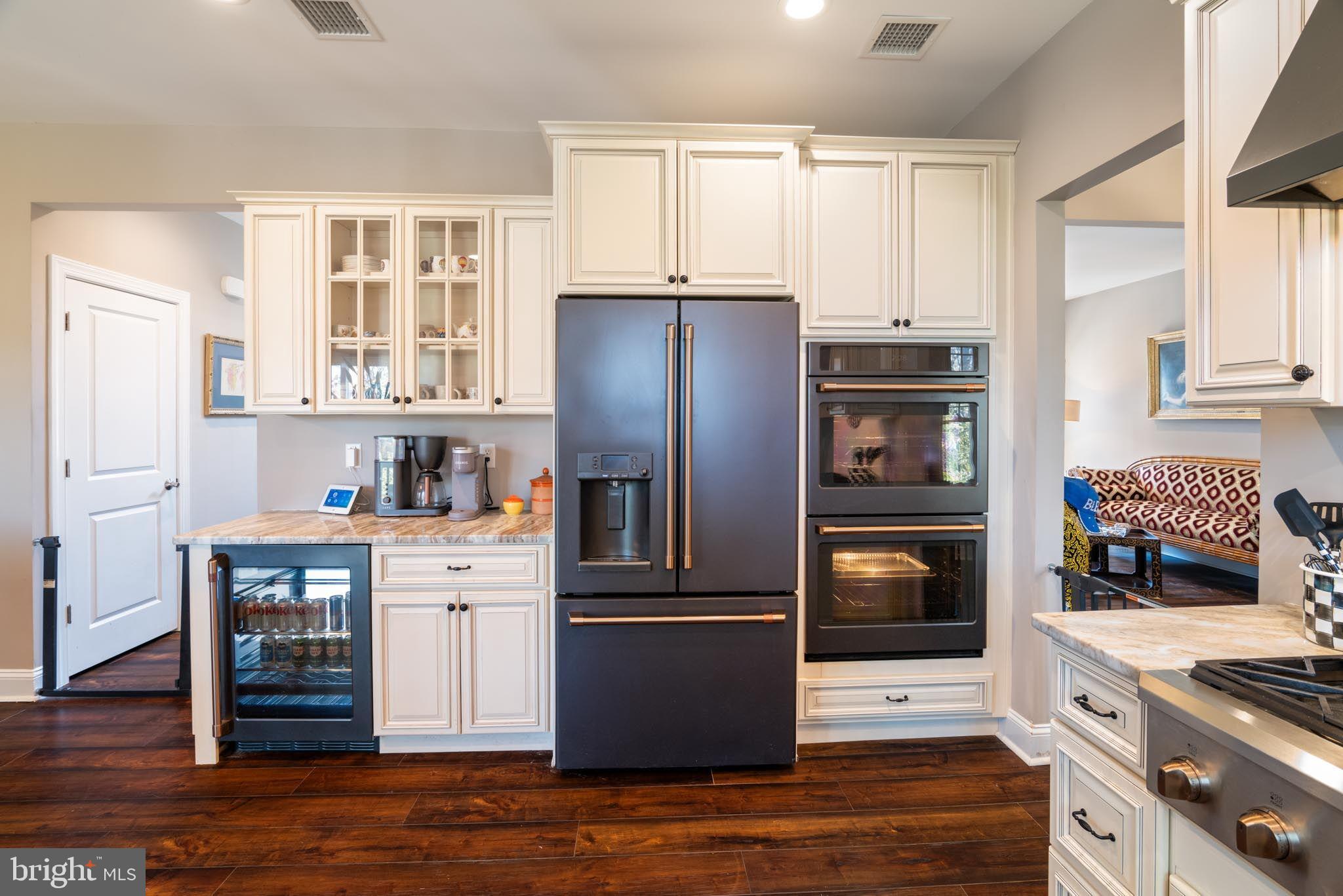 98 Alexander Drive Barnegat, NJ 08005 - Photo 24 of 60 a kitchen with a refrigerator stove and wooden cabinets