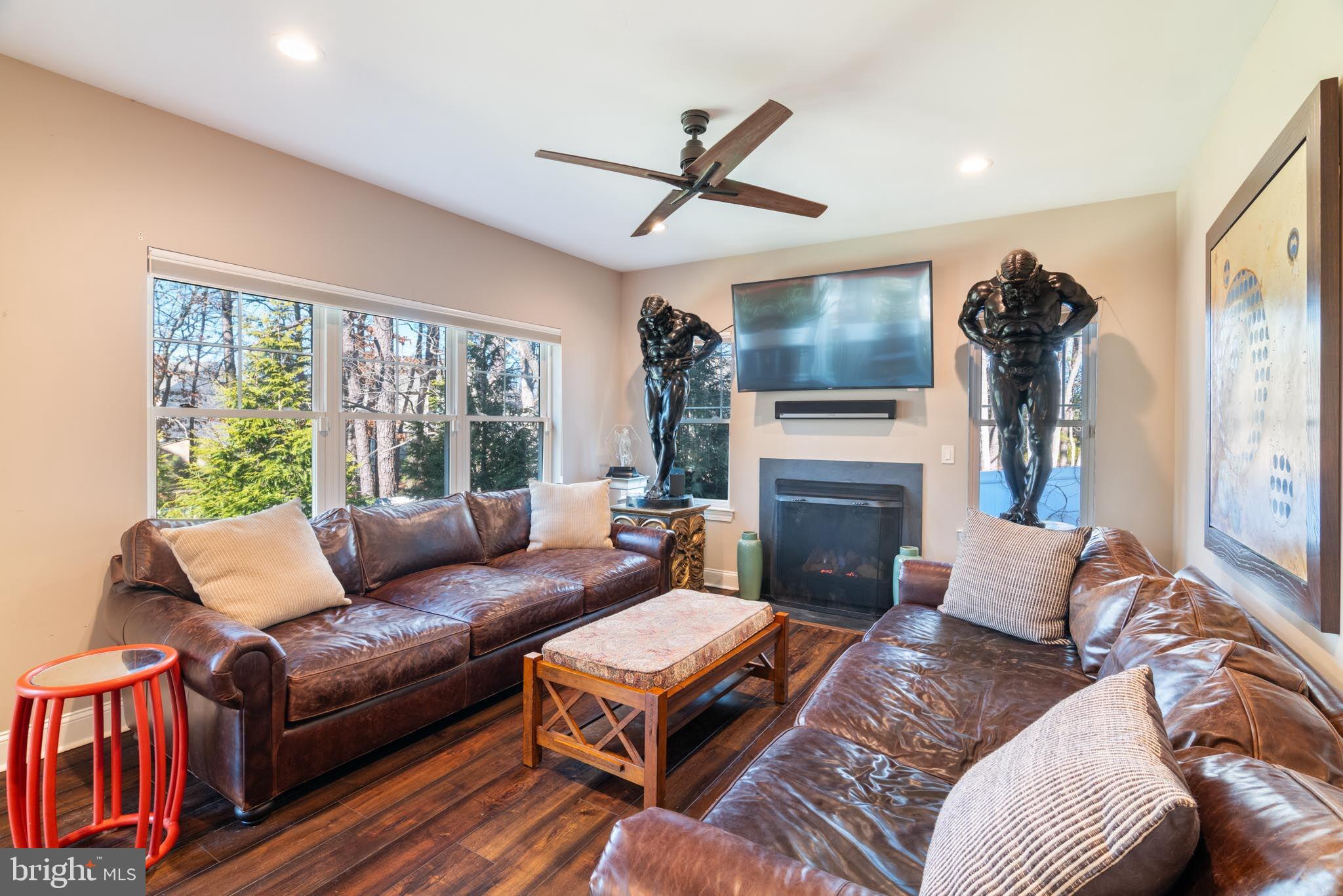 98 Alexander Drive Barnegat, NJ 08005 - Photo 28 of 60 a living room with furniture a fireplace and a flat screen tv