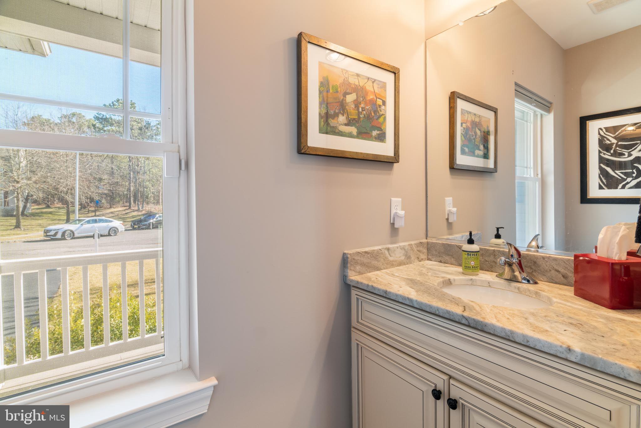 98 Alexander Drive Barnegat, NJ 08005 - Photo 42 of 60 a bathroom with a granite countertop sink and a large mirror