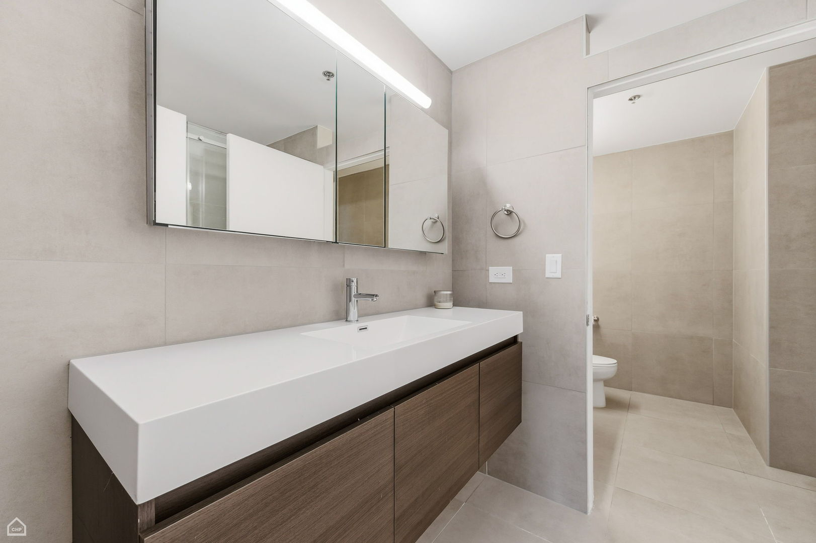 1000 East 53rd Street, Unit 215 Chicago, IL 60615 - Photo 11 of 17 a bathroom with a sink and a mirror
