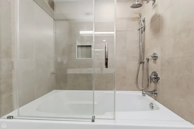 a bathroom with a bathtub and a shower