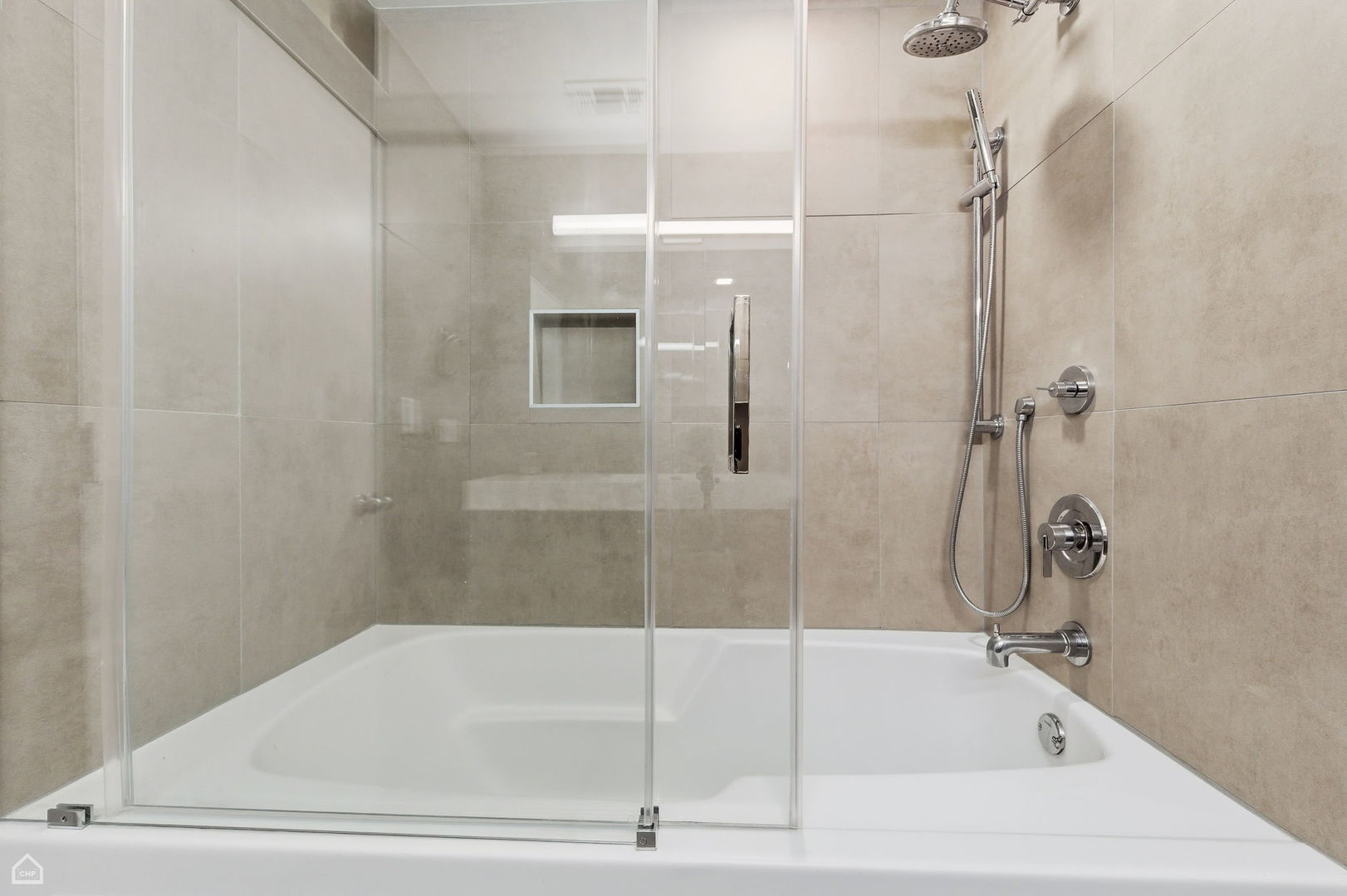 1000 East 53rd Street, Unit 215 Chicago, IL 60615 - Photo 12 of 17 a bathroom with a bathtub and a shower