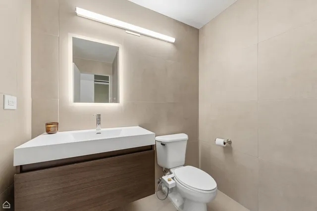 a bathroom with a sink a toilet and mirror