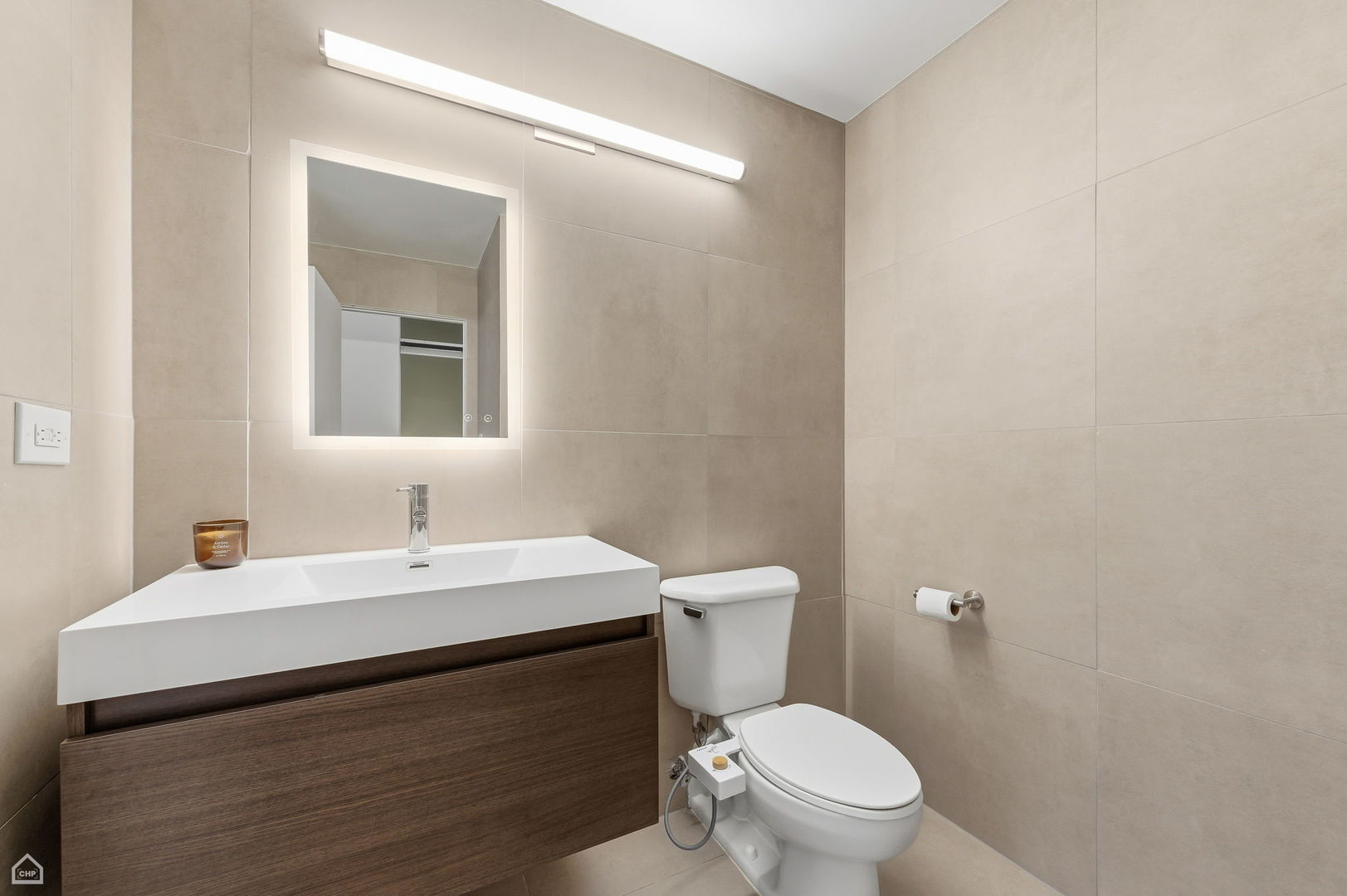 1000 East 53rd Street, Unit 215 Chicago, IL 60615 - Photo 13 of 17 a bathroom with a sink a toilet and mirror