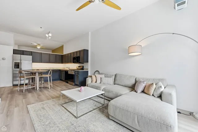 a living room with furniture and kitchen view